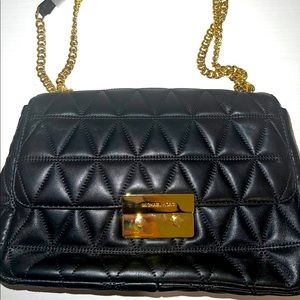 Black shoulder Micheal Kors bag with gold